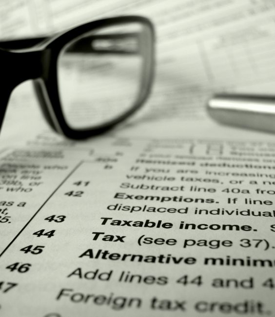 glasses and pen on tax forms