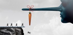 group of people running towards a carrot tied to a liar nose