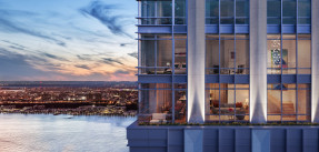 Closeup of a luxury condo building, from the outside, with a spectacular city view