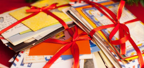 Stacks of letters and cards wrapped in red ribbon