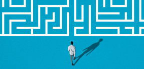 a man walking toward a white maze