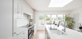 bright white kitchen with induction oven and skylight