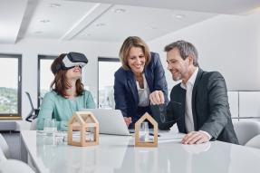 Business meeting with VR glasses and architectural models