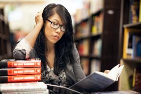 Business woman reading books in library