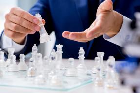 Businessman playing chess in office
