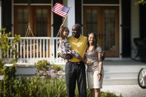 A Family waving an American flag