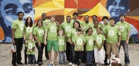 Group of volunteers in matching green shirts