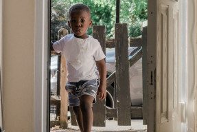 Black child entering a home