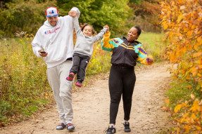 African American couple walking on a trail with their daughter