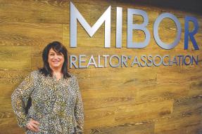 Shelley Specchio in front of MIBOR sign