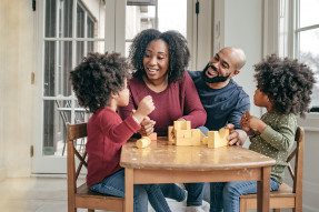 African American family playing at kids' table