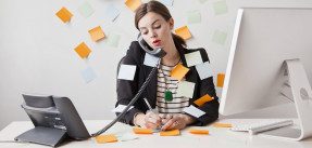 young woman working in office covered with adhesive notes