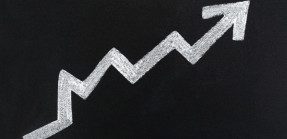 A bold white arrow indicating rise and falls of inflation over time, pointing up at the end.