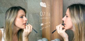 woman applying makeup by smart mirror