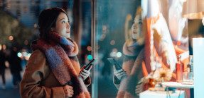 Woman window shopping in winter