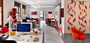 Pops of red energize this office space.