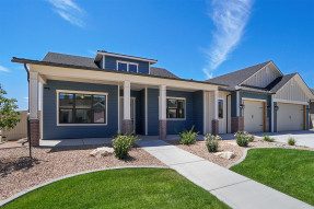 Blue-gray house with lawn and gravel landscaping
