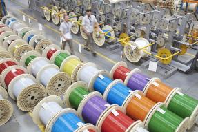 Colorful spools of optic cables in a factory