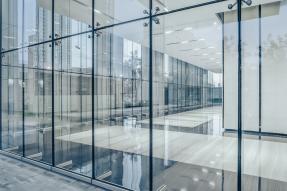 Commercial building corridor seen through glass walls