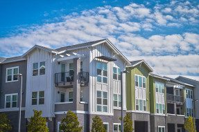 Condos, blue sky, white clouds