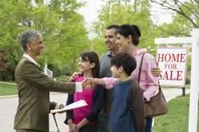Family shaking hands with real estate agent