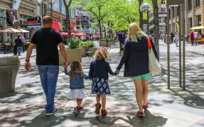 A family of four walks in downtown Denver