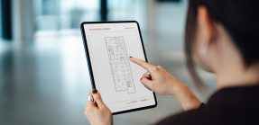 Woman looking at floor plan on mobile device