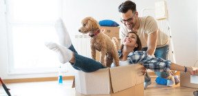 Young couple with dog moving into new apartment