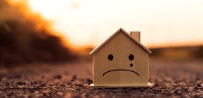 House model with unhappy face