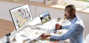 Real estate agent working with design elements at desk