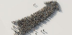Crowd of people forming an arrow