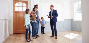 real estate agent showing family a home