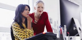 Mature business woman mentoring younger employee