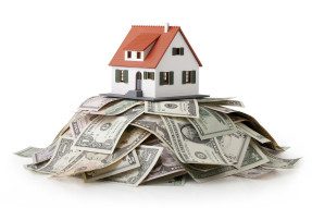 House model sitting on top of a money pile