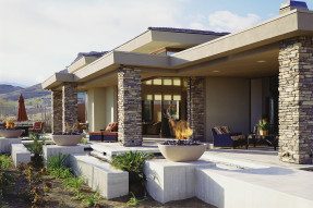 Modern house with large outdoor patio and firepits