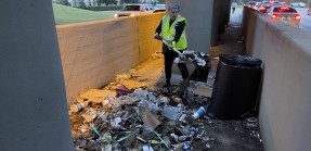 Real estate pro Jennifer Richardson cleans up trash under a highway overpass in Baton Rouge, La.