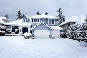 Large blue-gray house in the snow