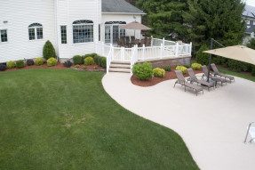Looking down at back yard and patio of luxury home.