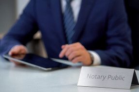 Male notary public viewing files on tablet