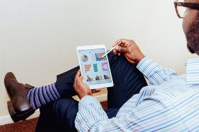 Man looking at charts on a tablet