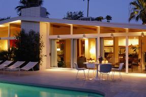Modern house exterior at dusk, with patio and pool