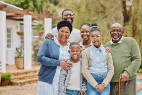 Multigenerational Black family standing together in garden