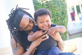 African american father holding his son