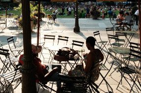 People sitting at outdoor cafe tables