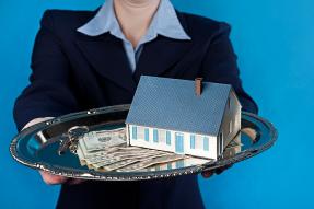 Person offering keys, money, and a house on a silver platter