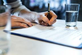 Person signing a legal document