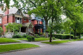 Red brick Victorian house on tree-lined street