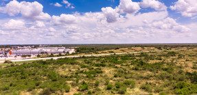 Undeveloped land near a large building in Texas