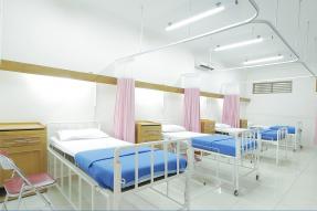 Row of hospital beds and curtains