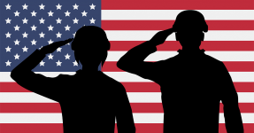 Silhouette of military personnel against U.S. flag